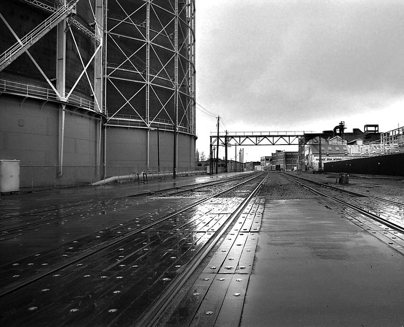 Rail infrastructure and gas storage tanks, near the Port of Oakland, 1976.