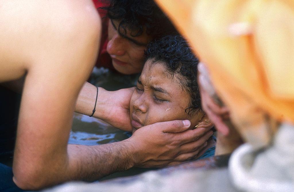 A rescuer helps Omayra Sánchez who was caught in a lahar as it flowed from the erupting Nevado del Ruiz volcano in Colombia.