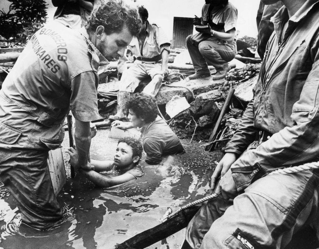 Men attempt to rescue Omaira Sanchez who is trapped in debris from the eruption of Nevado del Ruiz Volcano in Armero, Columbia