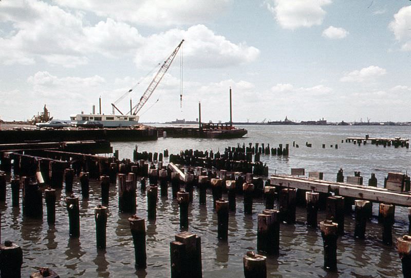 Ellis Island and industrial Jersey City shoreline across the Hudson with abandoned CRRNJ railroad terminal, June 1973