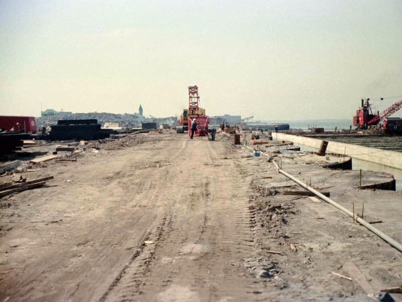 Battery Park City landfill edge by Hudson being constructed looking south to Pier A, 1974