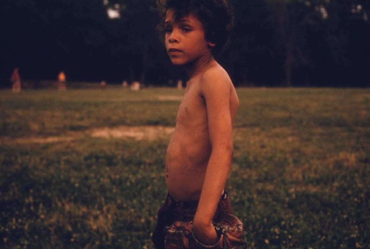 Puerto-Rican boy playing softball in Brooklyn’s Hiland Park, July 1974.