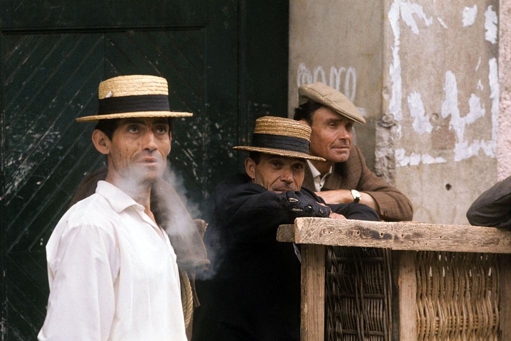 Hammock-bearers smoking during a break. Madeira, 1971