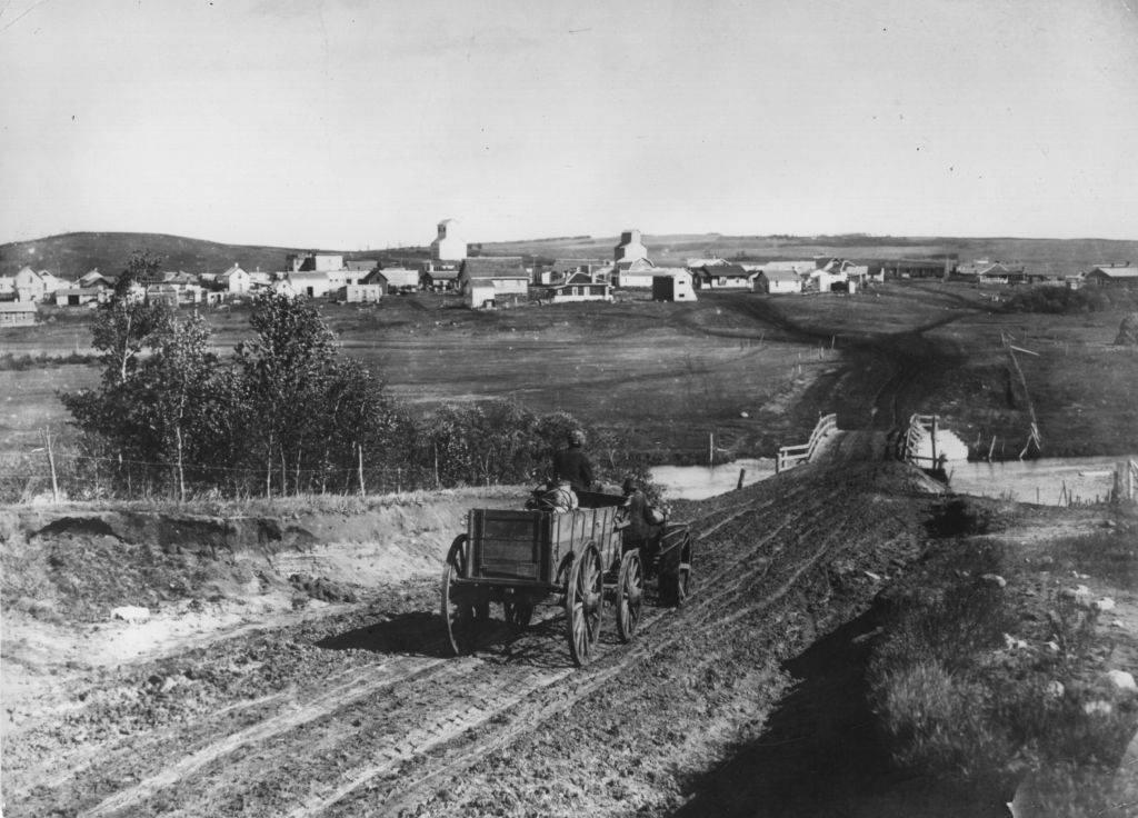 A cart drives down the road to Turtleford, Saskatchewan. January 1910.