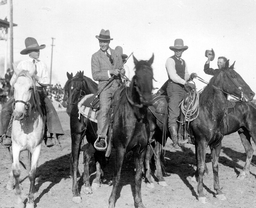 The Duke of Windsor, (second from left), as Edward, Prince of Wales, riding with cowboys at Saskatoon during a royal tour. October 1919.