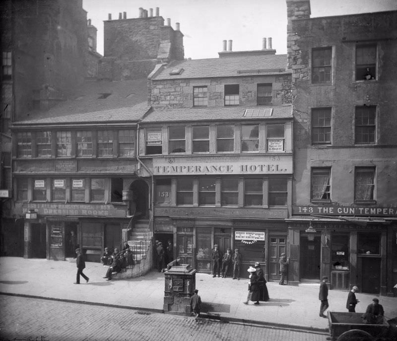 High Street between Canongate and North Bridge, Edinburgh showing no 153 Allan Ramsay's House, The Temperance Hotel, no 143 The Gun'Temperance and The Gun Coffee House, c. 1900.