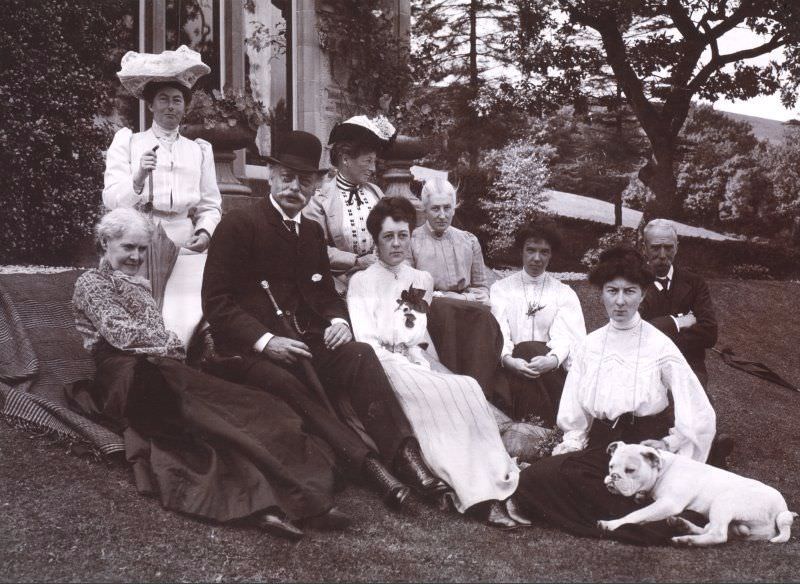 Group of people sitting in garden, 1905. Titled: 'Aikenshaw July 1905. Miss Louise Stuart, Miss Grant, Mr Parker, Miss Parker, Francess, Mrs Jameson, Miss Davidson, Jessie, Mr W S Turnbull, Stroncher'.