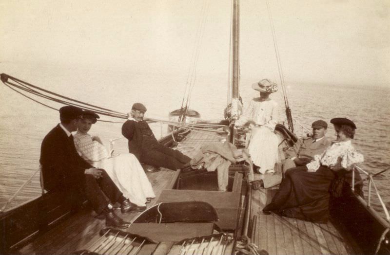Group on sailing boat, probably 'Gadfly,' c.1904. Titled: 'Sunday afternoon cruise Brodick. Jack Swan, Monty Murray, Johnson family'.