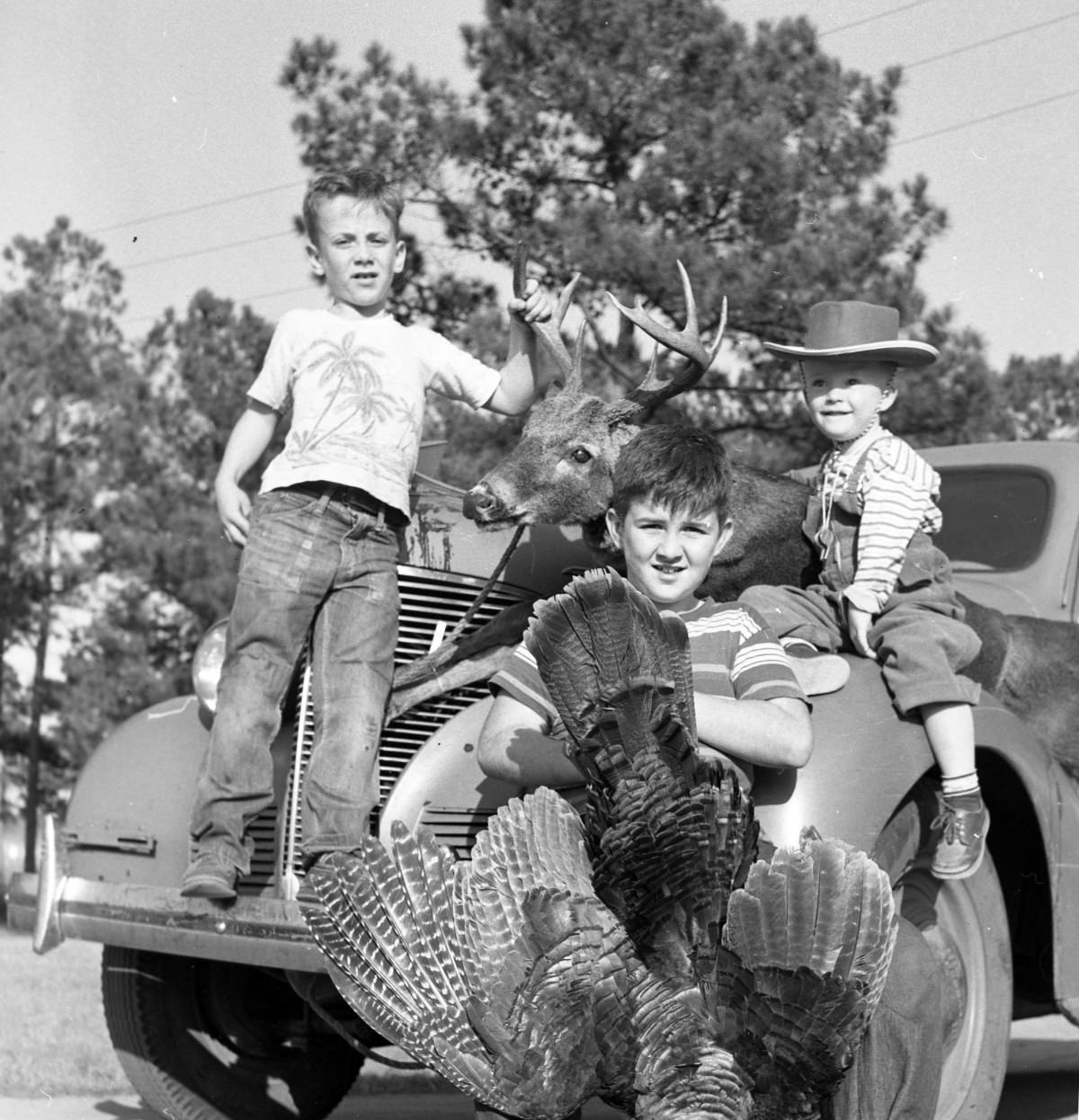 Clark children with deer and turkey from a successful hunt – Jan 9 1955