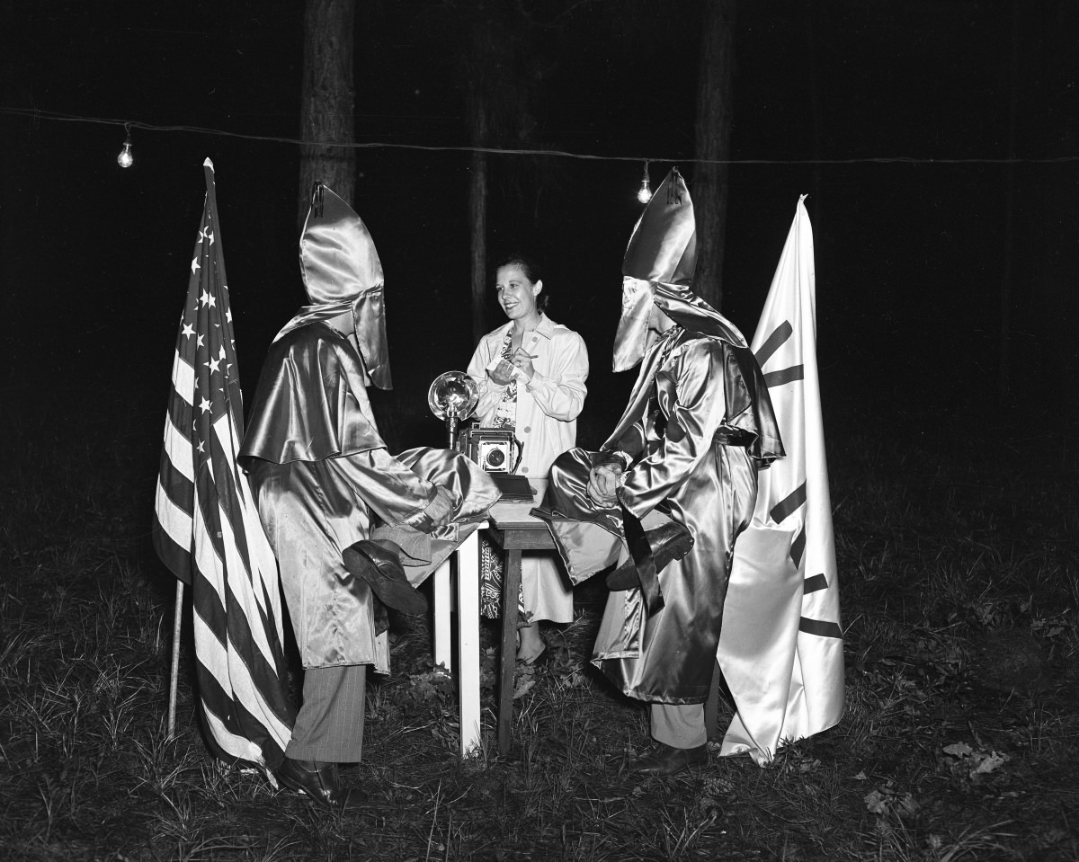 Ku Klux Klan officers in costume talking with the photographer’s wife Sarah Catherine Kerce, 1956