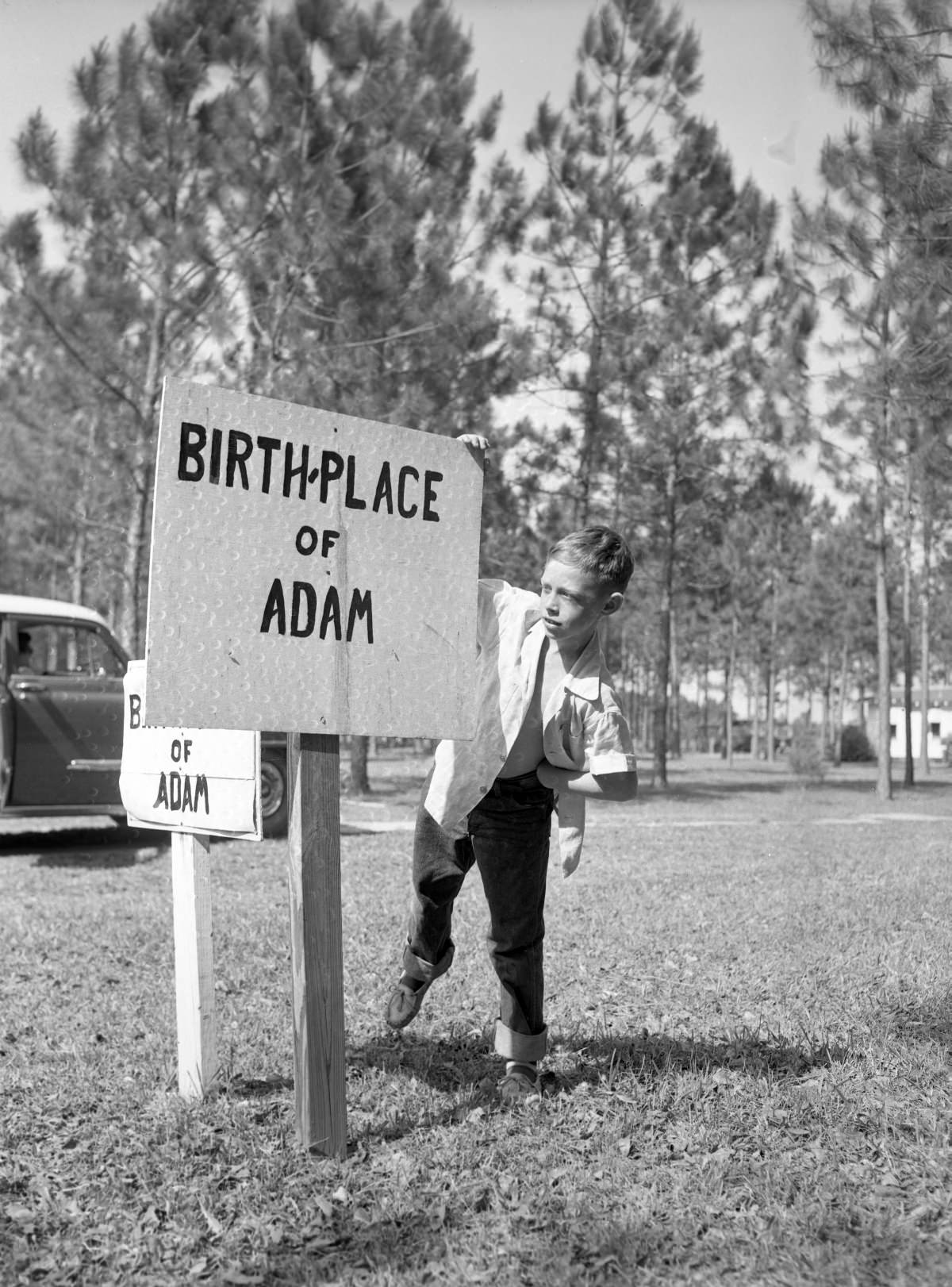 Joe Kerce reading sign marking the “birthplace of Adam” in the Garden of Eden
