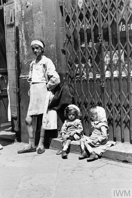 An emaciated mother with her twin daughters in the ghetto.