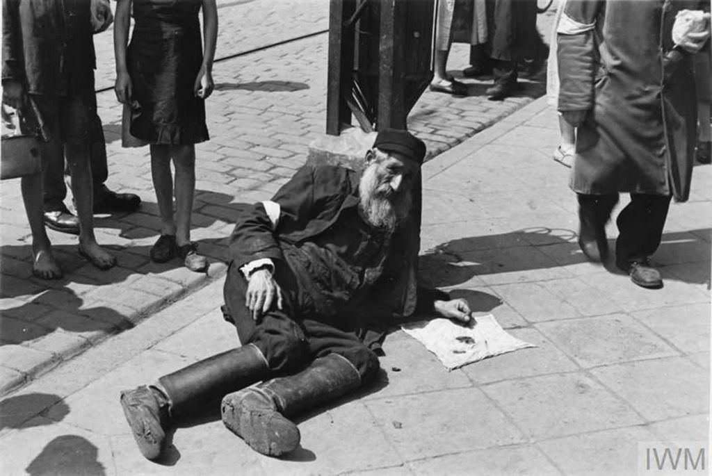 An elderly man lying on the pavement.