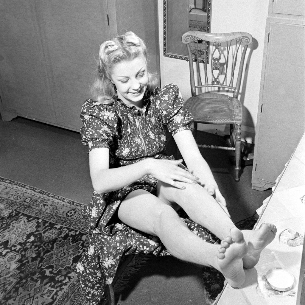 Another woman applying liquid stockings during World War II, 1941.