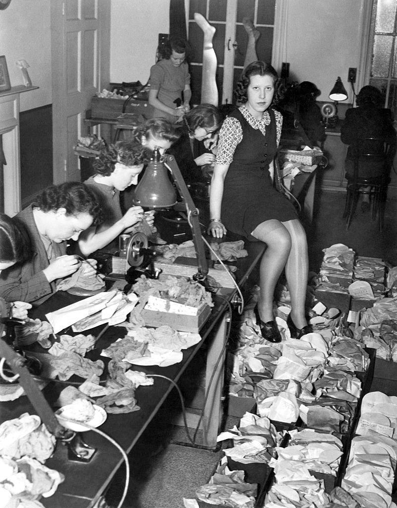 A staff of 20 girls working full time to repair the old stockings. January 1941