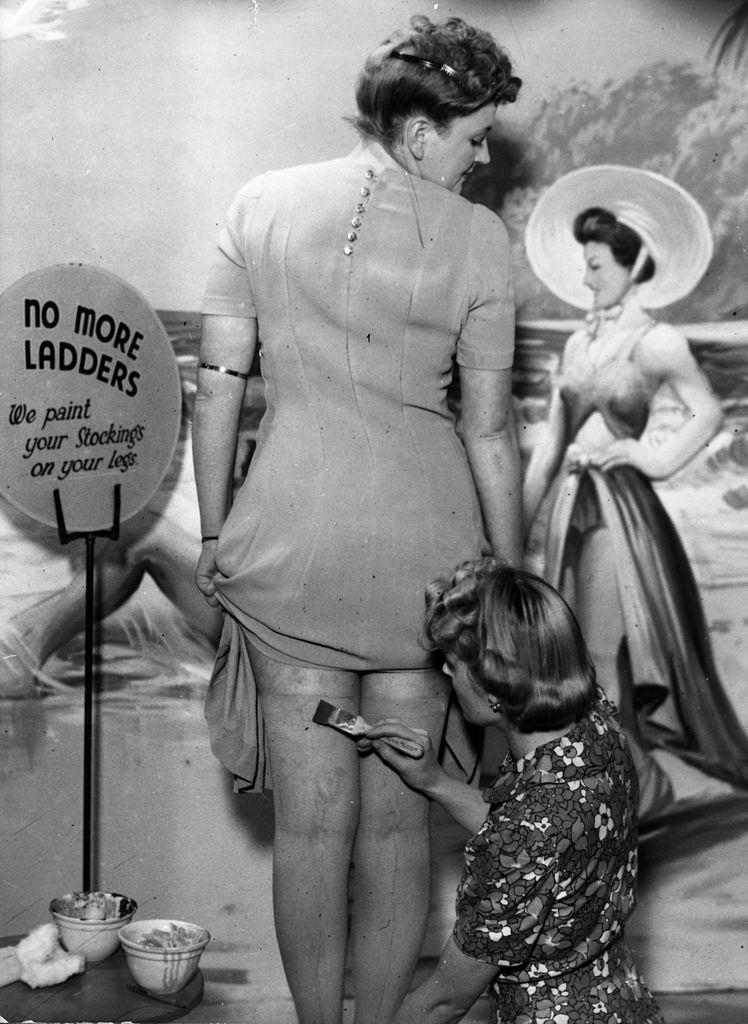 A beautician at the newly-opened Bare Leg Beauty Bar at Kennard's store in Croydon paints stockings onto a customer's skin.