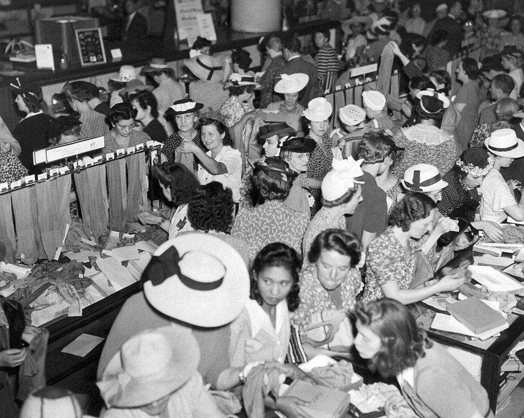 Crowds of women are buying silk stockings at Gimbels Department store in anticipation of a wartime silk shortage, New York. 1941