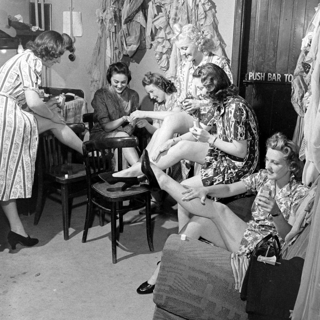 Women applying liquid stockings during World War II, 1941