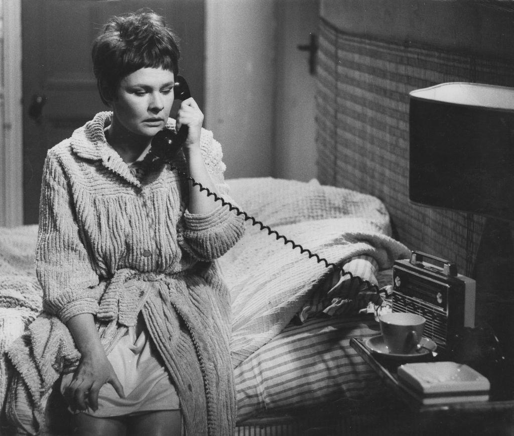 Judi Dench using a telephone in bed, in a scene from television series 'Talking to a Stranger', June 15th 1966.