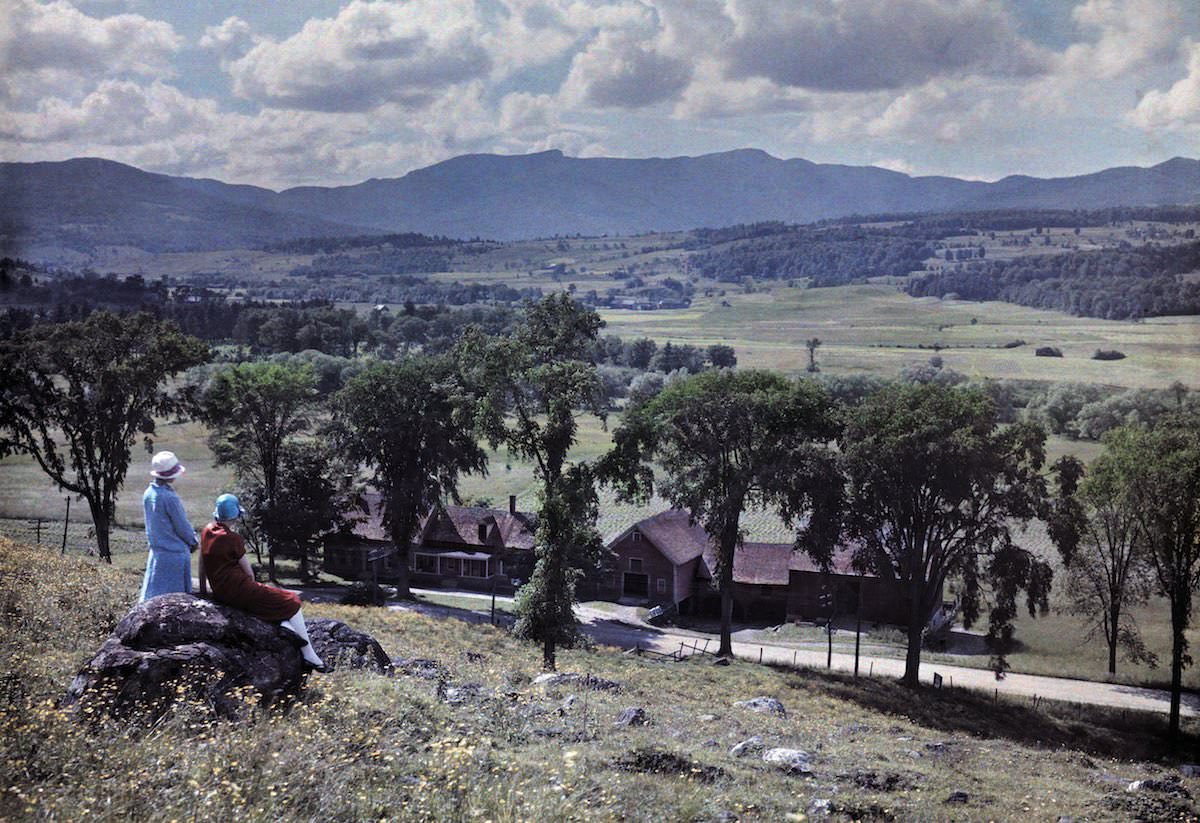 Two women look west from Stowe’s village towards Mount Mansfield, Vermont.