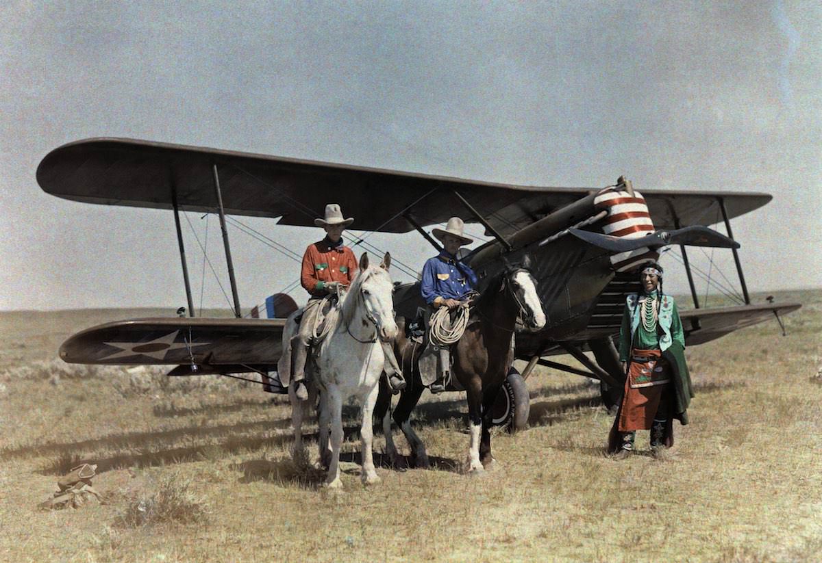 Three men stand in front of a plane on the Crowe Reservation in Montana.