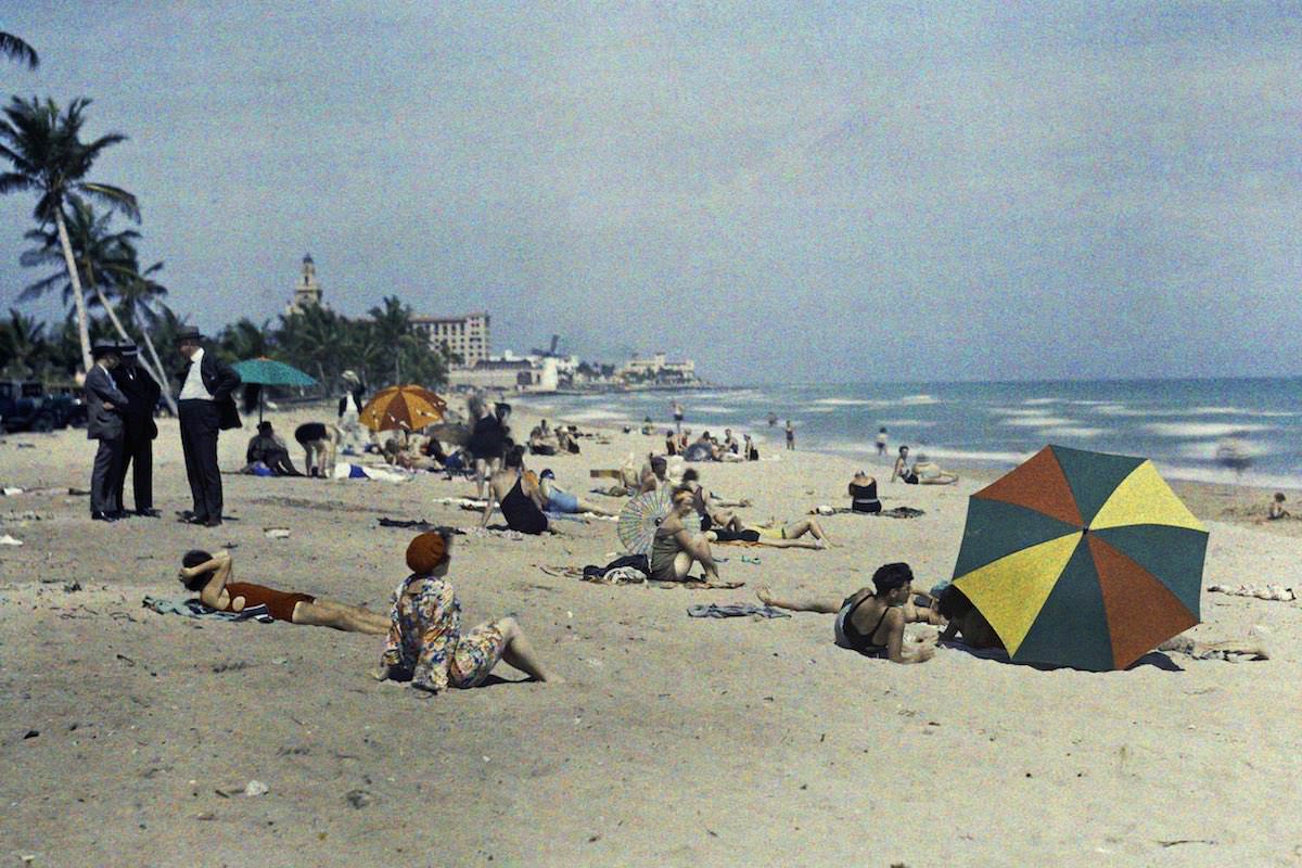 A group of people relaxing on the ocean coast, Miami Beach, Florida.