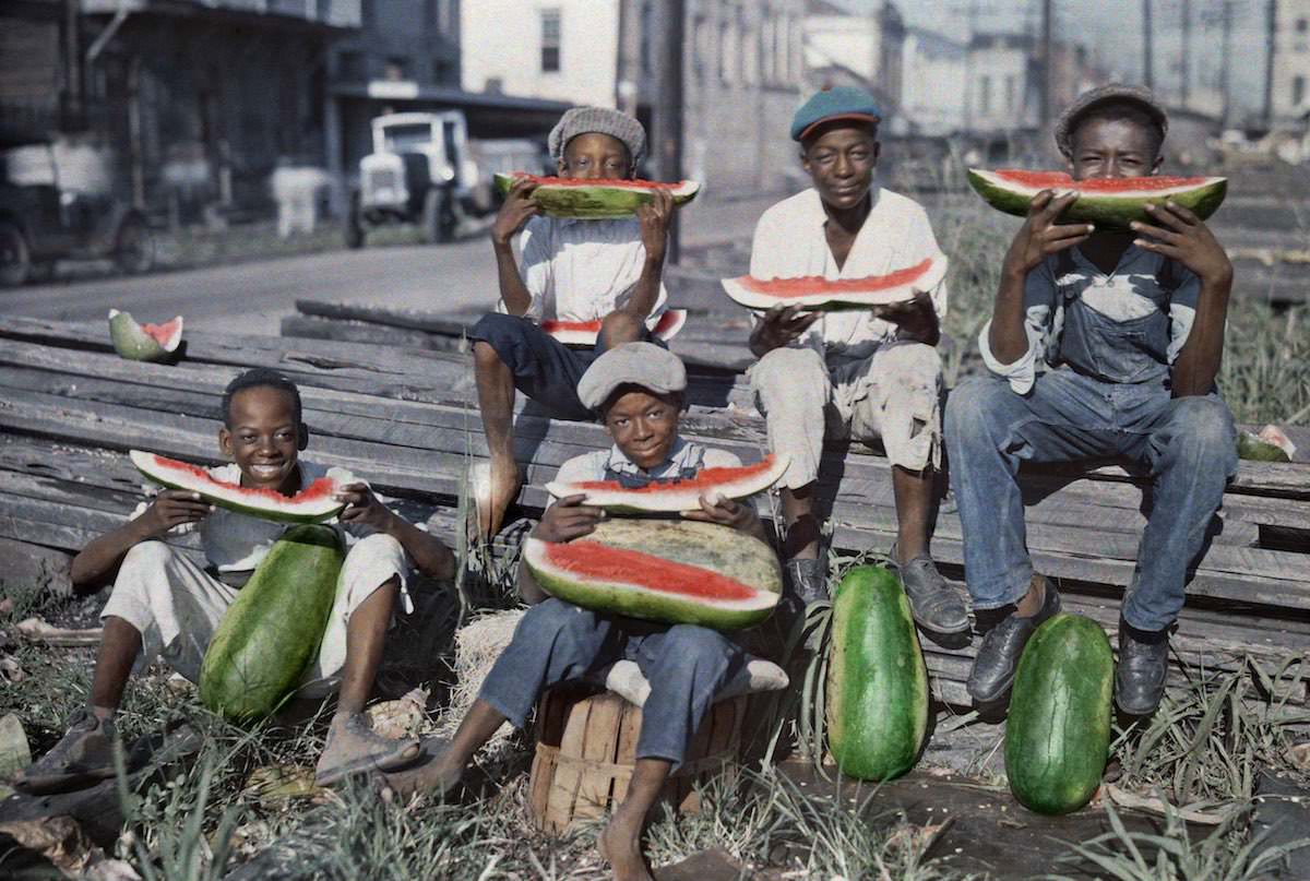 Five boys eat watermelon in New Orlean.