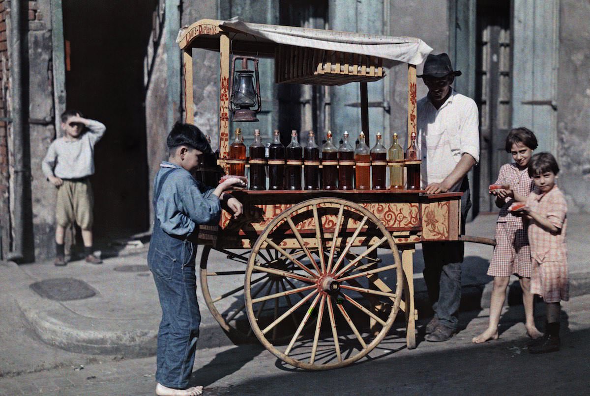 Children gather around a snowball vendor, New Orlean.