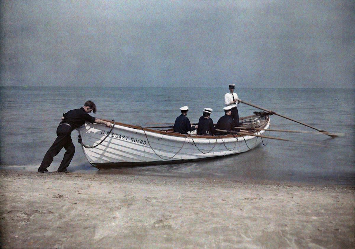 Coast Guard officers set sail in their boat.