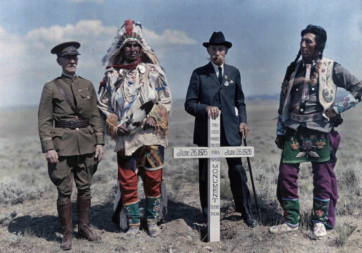 Men stand next to the monument to the Seventh Cavalry. Crow Indian Reservation, Montana