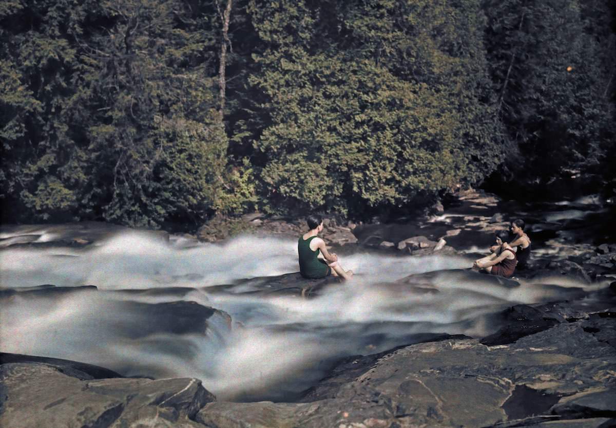 Vacationers by a running river on a warm summer day.