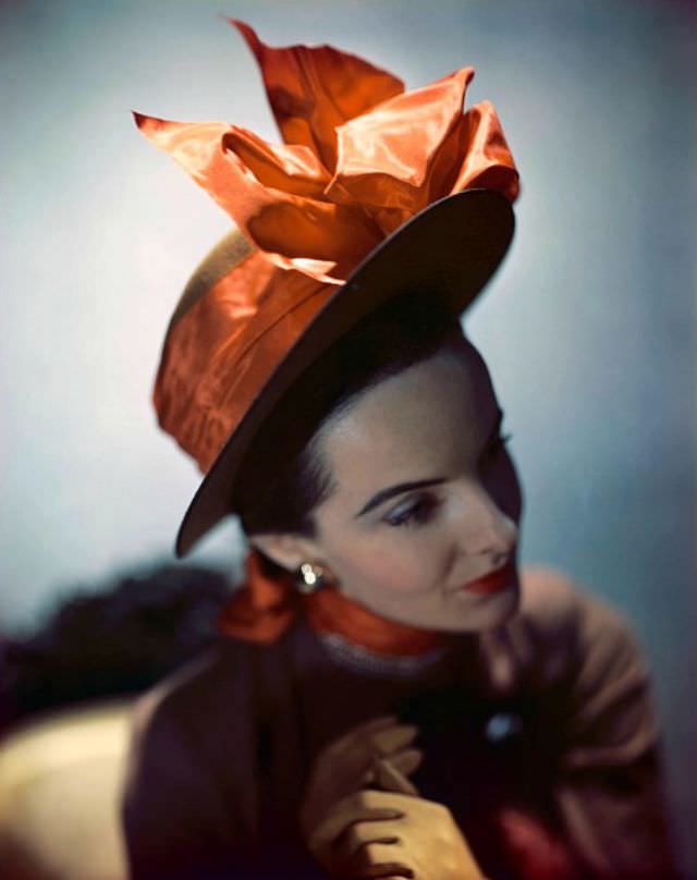 Model in toast colored sailor adorned with tangerine taffeta bow, Vogue, 1946