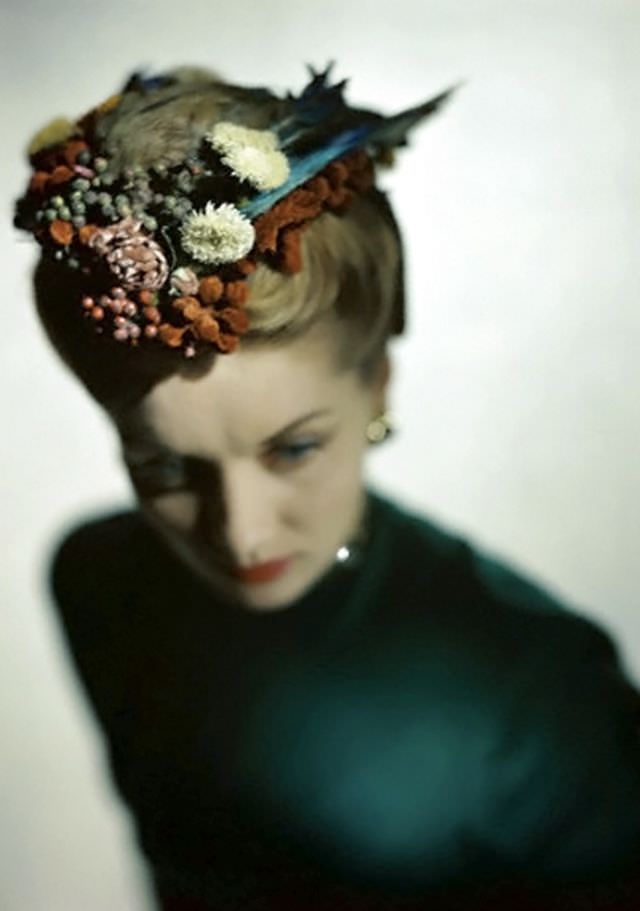 Model wearing Lilly Daché's bonnet-coif of flowers, feathers, and fruit, 1946