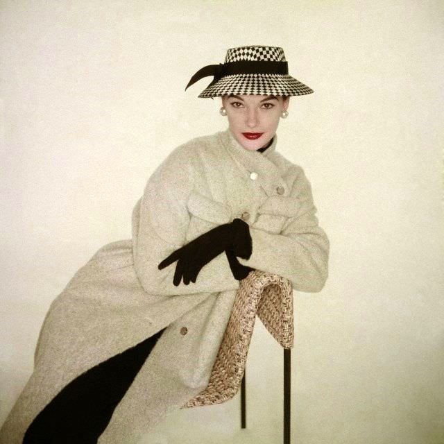 Model wearing neutral colored coat by Kraeler together with hat from, January 1953