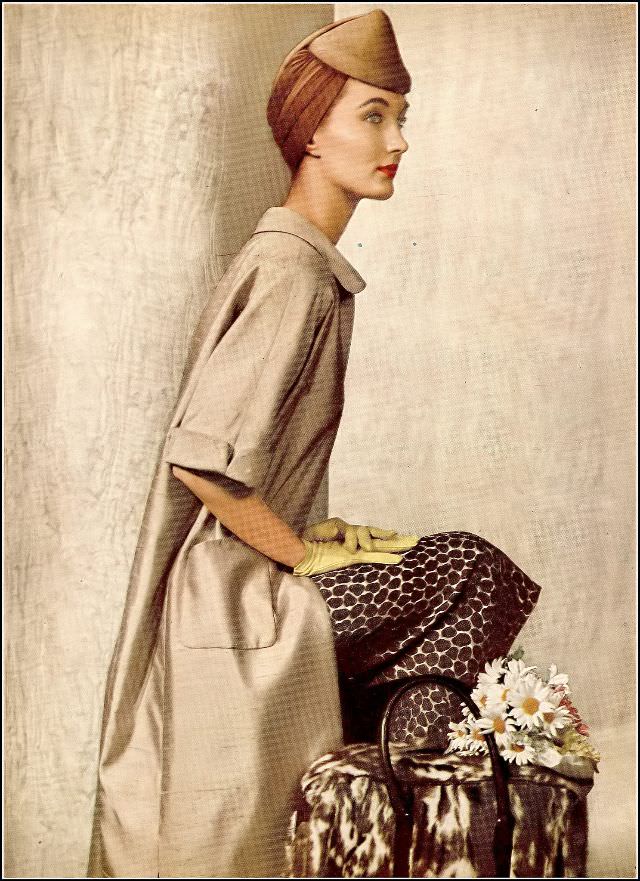 Evelyn Tripp wearing a raw silk coat lined in the same silk surah print of the dress by Adele Simpson, toque, fur carryall from Lord & Taylor, Harper's Bazaar, 1954