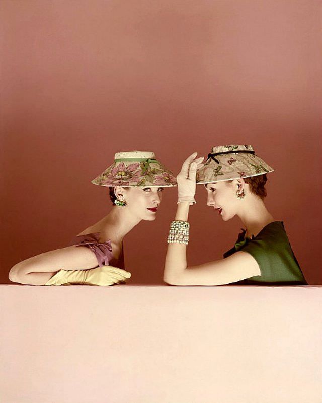 Mary Jane Russell and Cherry Nelms wearing shade-brimmed hats both by Lilly Daché, Vogue, March 1, 1954