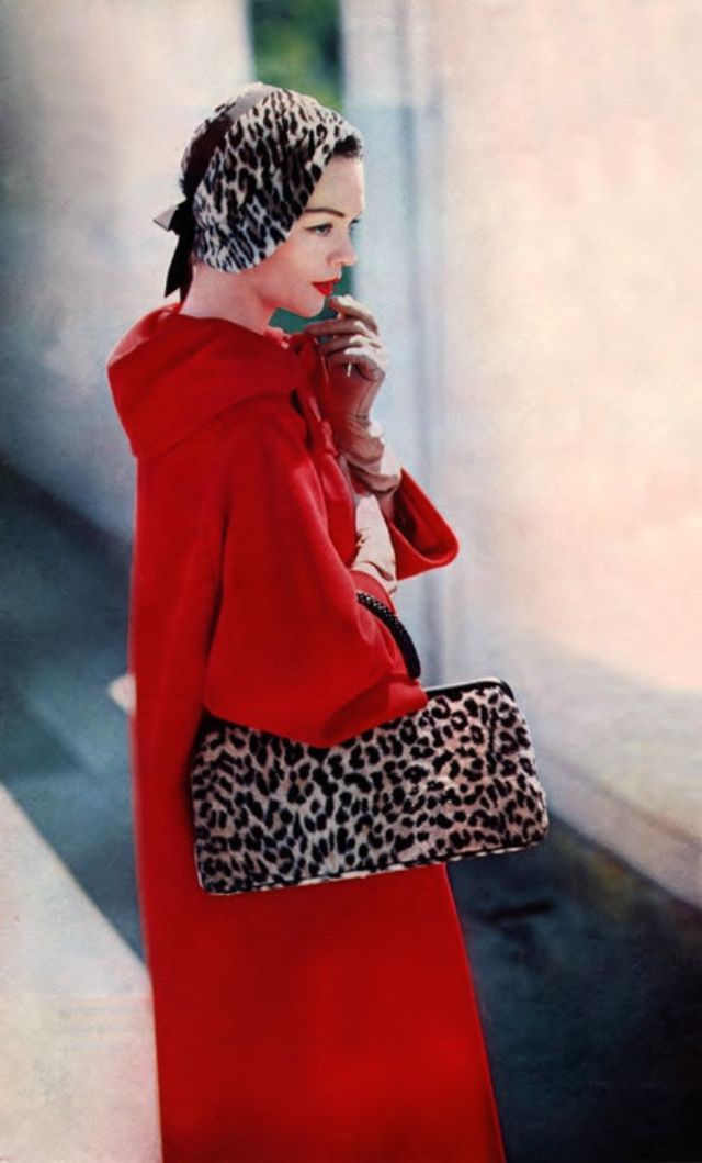 Model wearing a coat by Dan Millstein, hat by Lilly Daché, October 1957