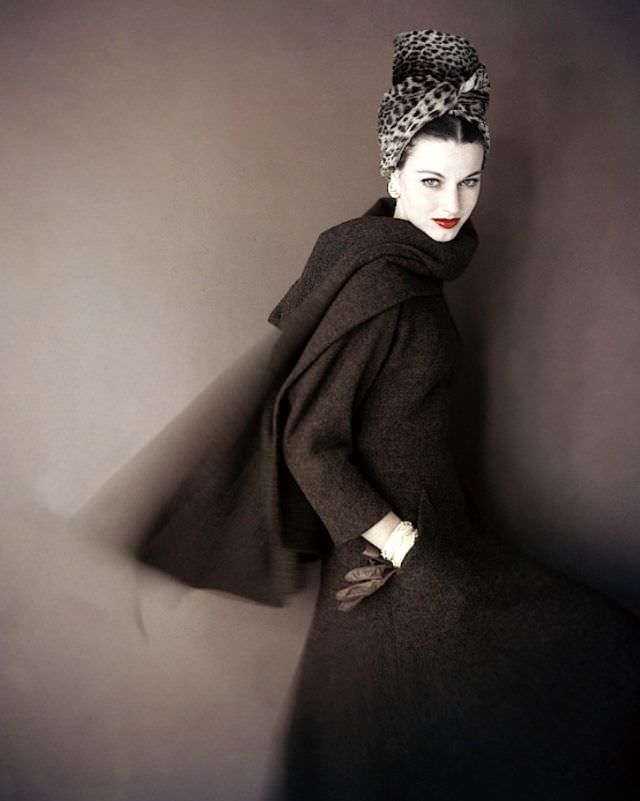 Model is wearing a brown tweed walking dress with an interesting wrap of stole in the same tweed by Pauline Trigère and the tall turban is from, Vogue, September 1959