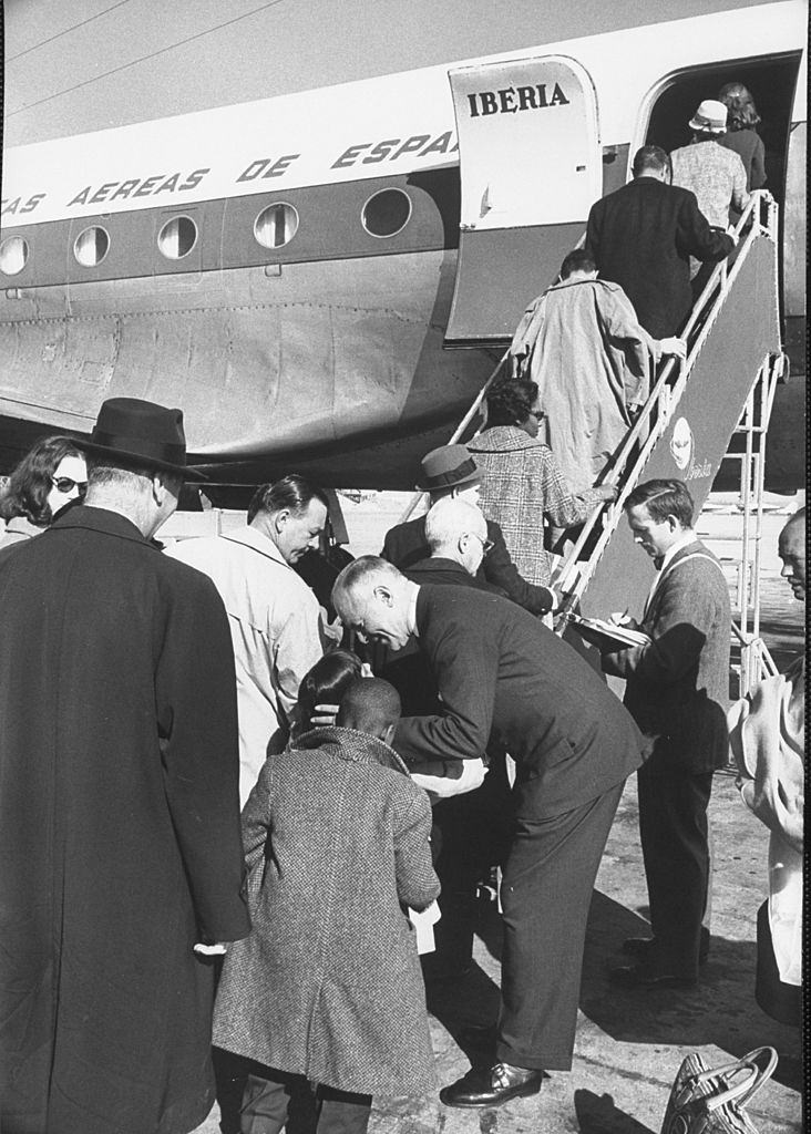 Members of touring Theater Guild American Repertory Co. boarding plane for engagement in Barcelona, 1960.