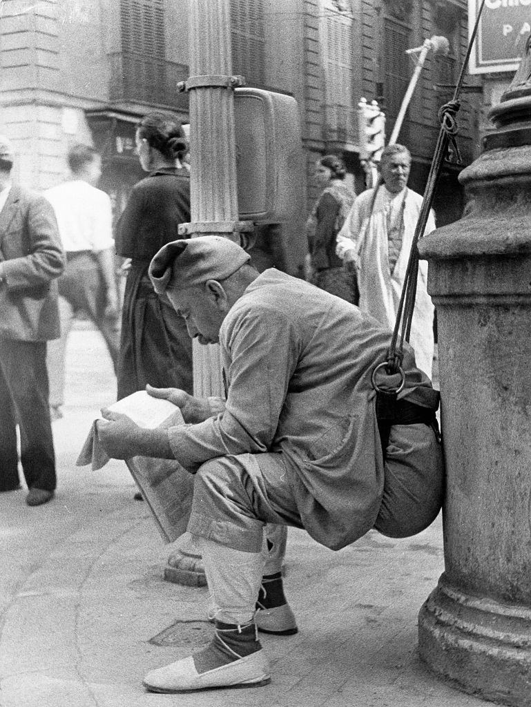 Commissionaire reading a newspaper in Barcelona, 1961.