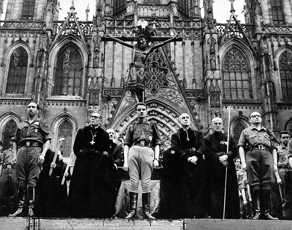 Clerics and soldiers in front of the cathedral Santa Eularia, Barcelona 1962.