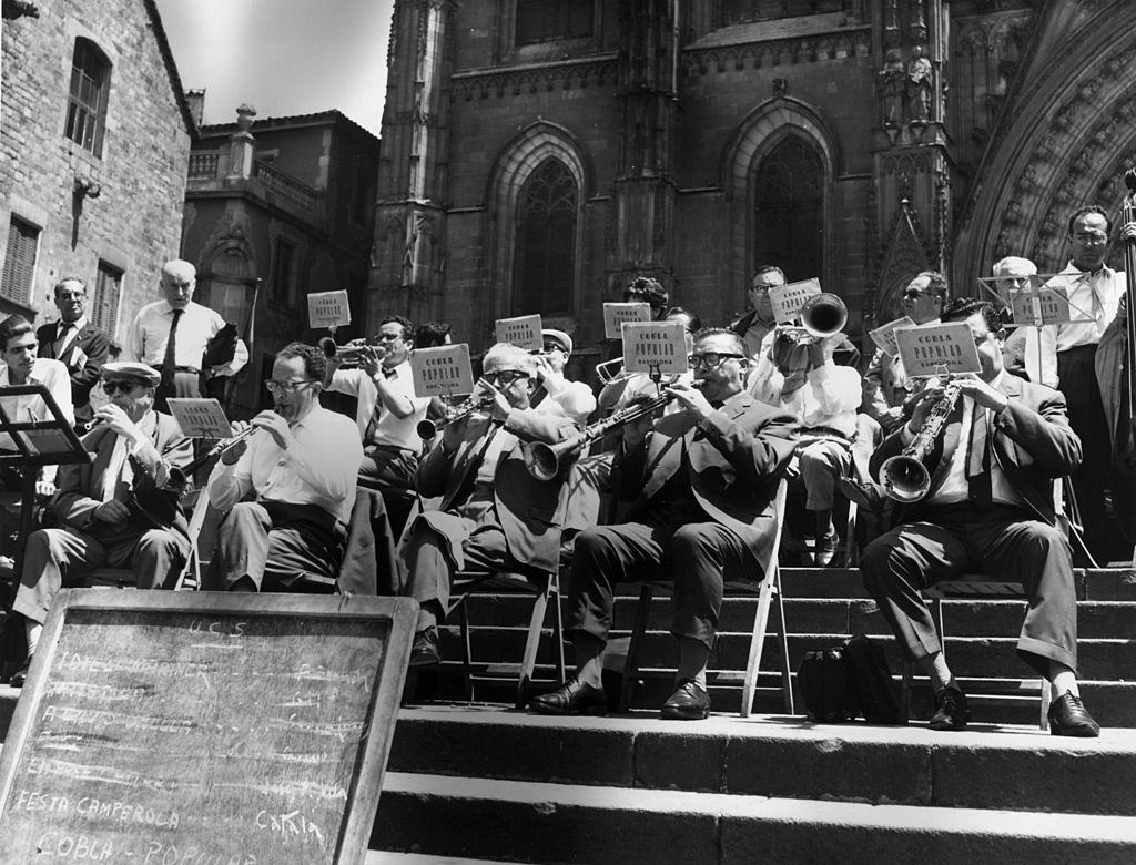 The Cobla Popular band playing on the steps of the cathedral in Barcelona, October 1966.