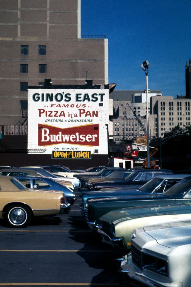 Gino's East pizzeria sign and parking lot, 1976