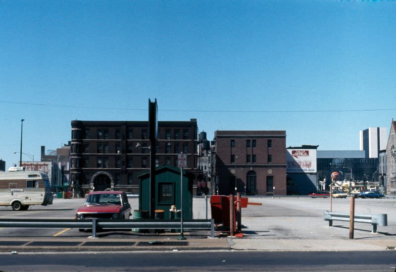 North State Street to the block of North Dearborn Street between West Ohio and West Ontario Streets, with a large parking lot in the foreground, 1976