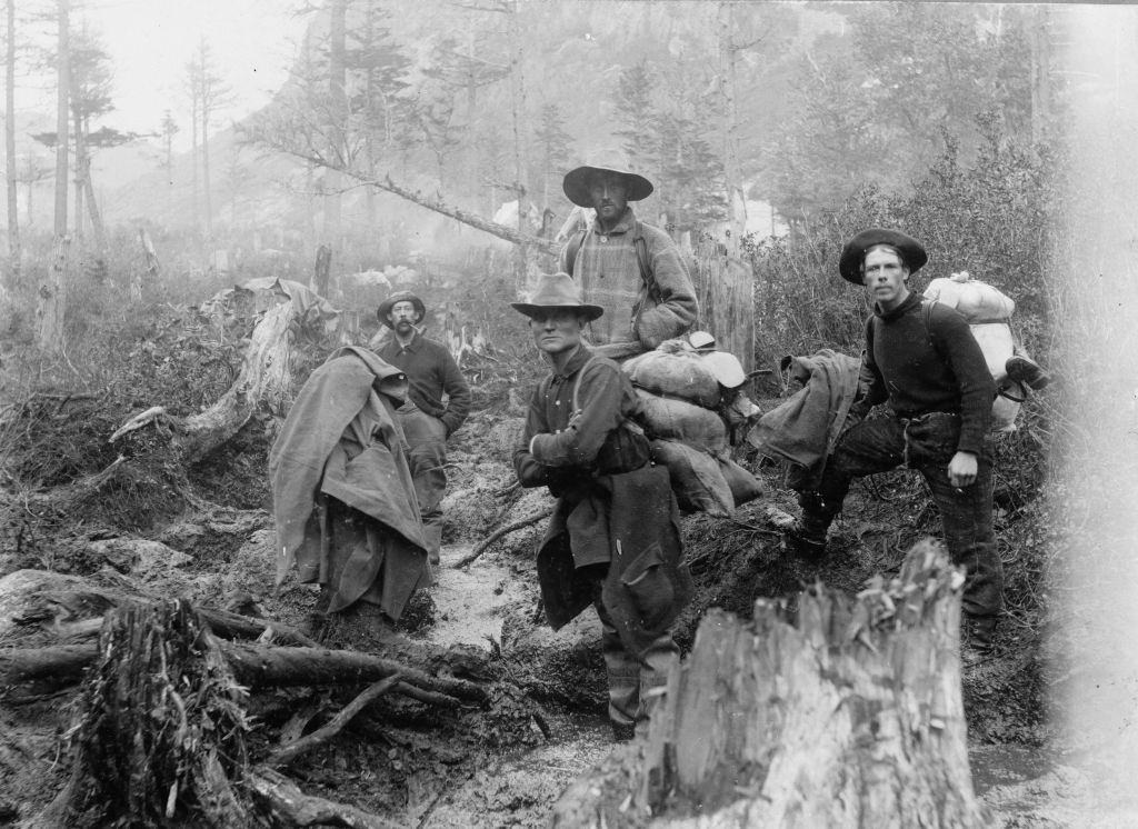 Ffour prospectors posed on a trail, Alaska, 1897.