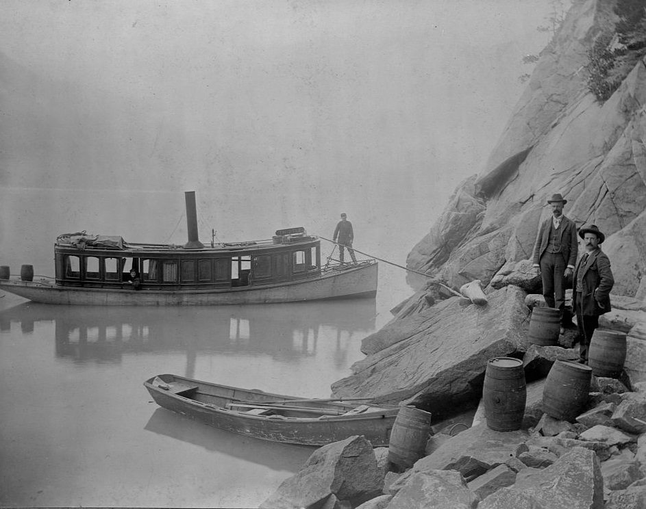 Two customs officals seize untaxed alcohol in Skagway, Alaska 1897.