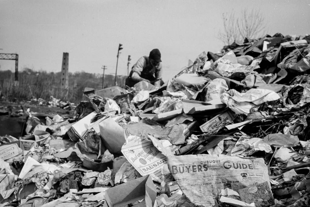 A man scavenges in the Dubuque city dump.