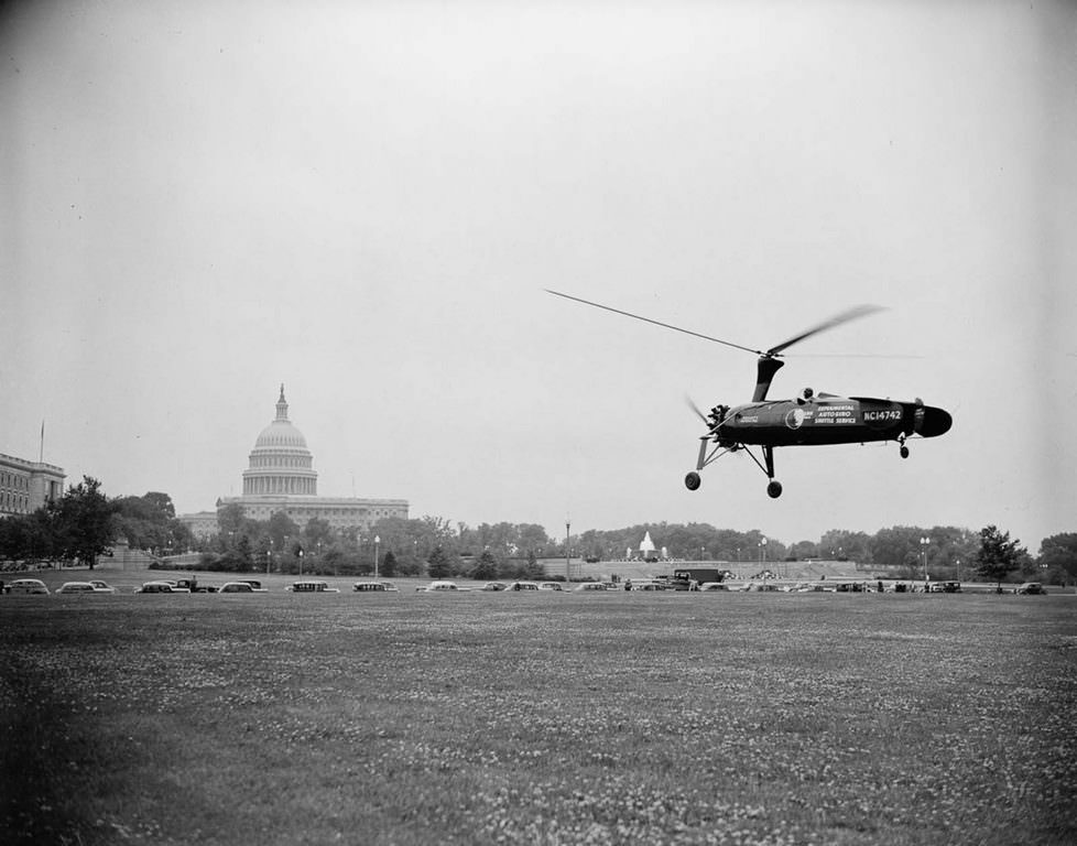 An autogyro lands on the grounds of the Washington, D.C. post office to demonstrate the feasibility of using autogyros to deliver mail. 1938.