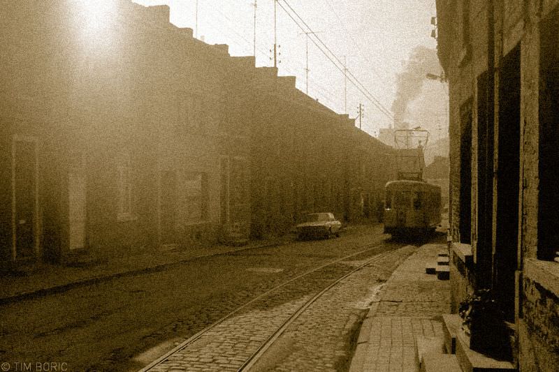 Tram on street with the cokes factory in Marchienne-au-Pont in the background. Dampremy, 1973