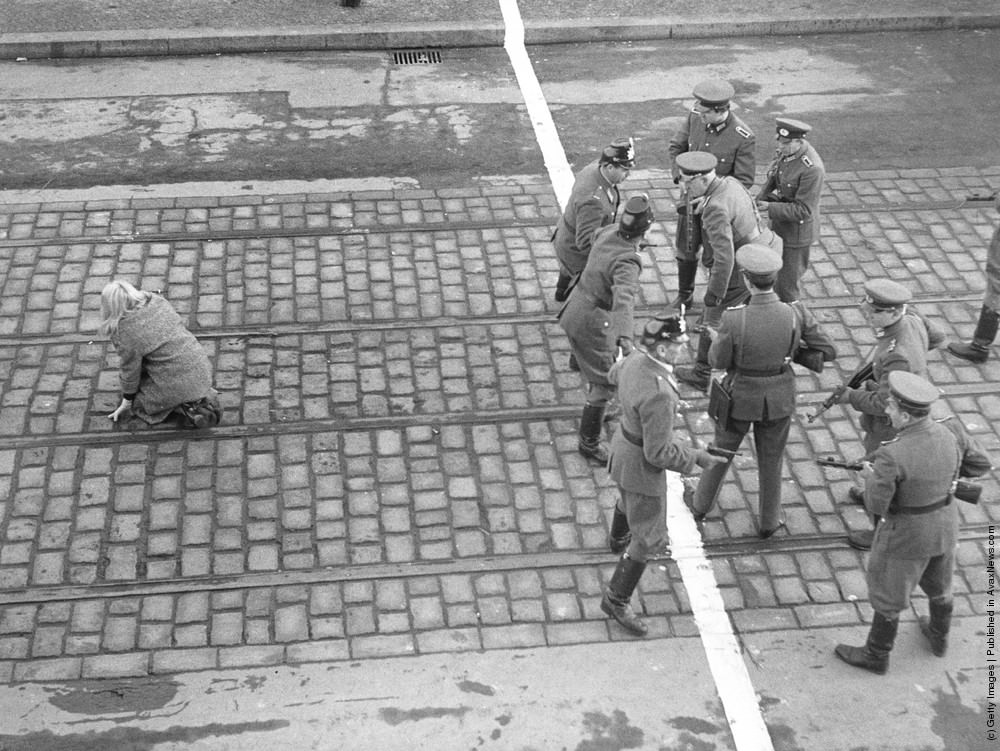 West Berlin policemen and East German Volkspolizei face each other across the border in Berlin.
